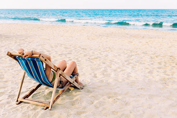istock Woman Relaxing On The Beach. 596365396