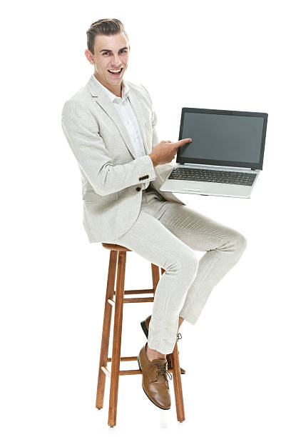 istock Smiling smart casual man pointing at laptop 596365604