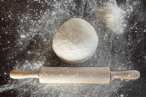 istock Dough and rolling pin with flour sprinkled lie on the 596366294