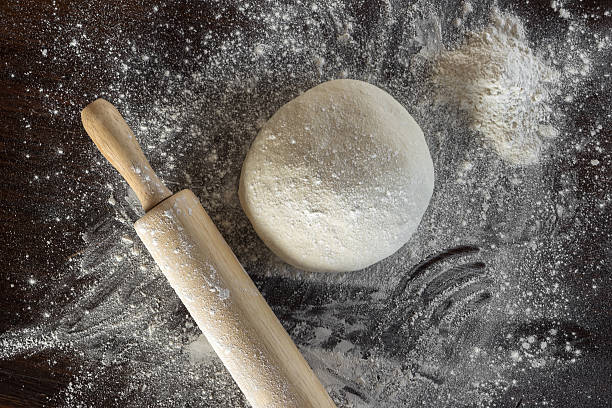 istock Dough and rolling pin with flour sprinkled lie on the 596366454