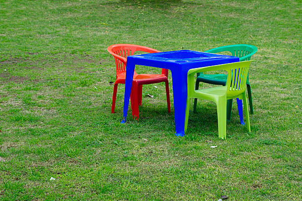 Colorful miniature plastic table and chairs on the yard stock photo