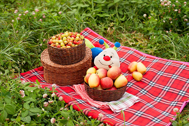 Apples and funny caterpillar on the grass.