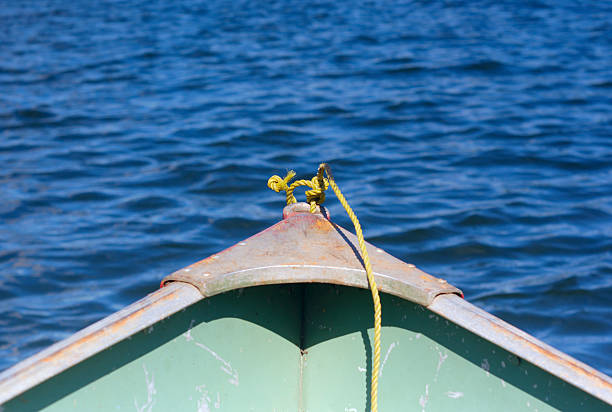 istock yellow rope in front of a shallop on a lake 596368584