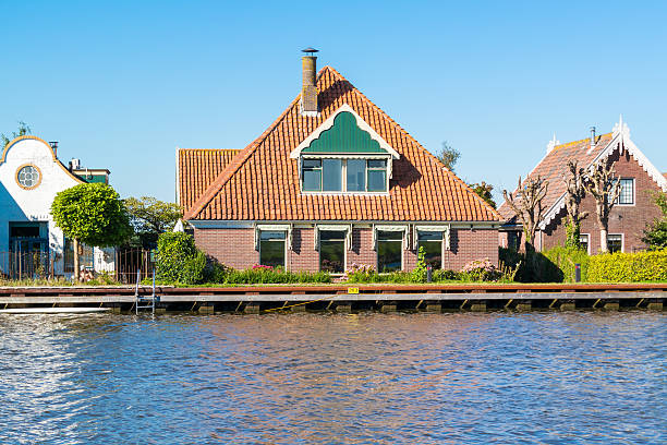 Oost-Graftdijk, Netherlands - August 17, 2016: Waterfront houses alongside Noordhollandsch Kanaal in Oost-Graftdijk, Alkmaar, North-Holland, Netherlands