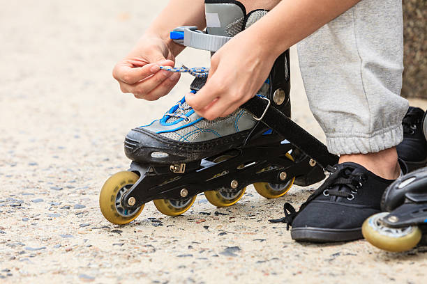 istock Woman putting on roller skates outdoor. 596369318