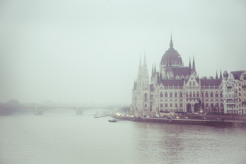 View of a Budapest parliament during the foggy day.