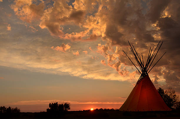 istock Teepee camp and gold, dark,  sunset- light in teepees 596370098