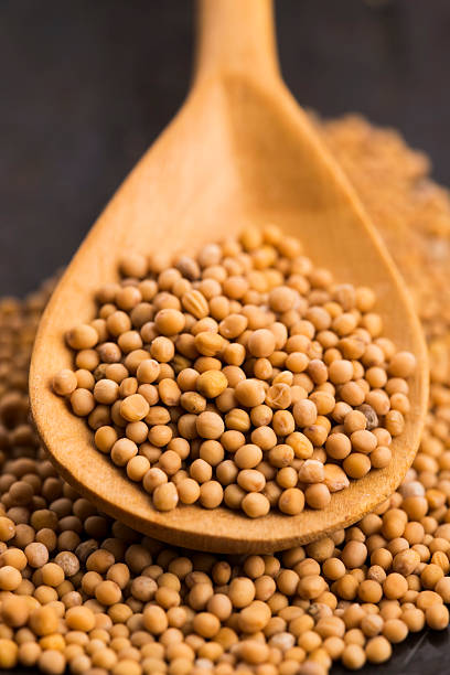 istock Spicy mustard seeds in a wooden background 596378504