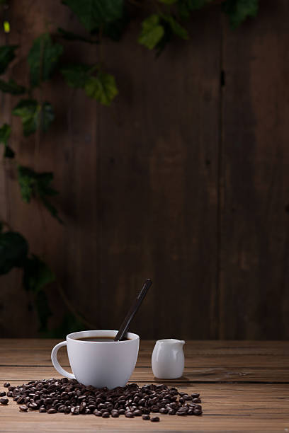 Coffee cup and coffee beans on wooden background
