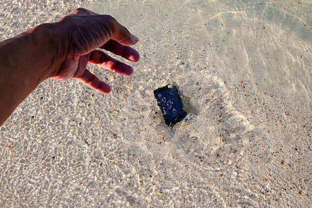 istock Mobile phone fall to the sea water. 596379826