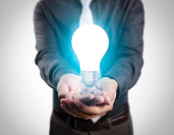 istock business person holding light bulb 596379952
