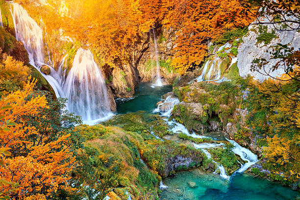 istock Autumn landscape with picturesque waterfalls 596380292