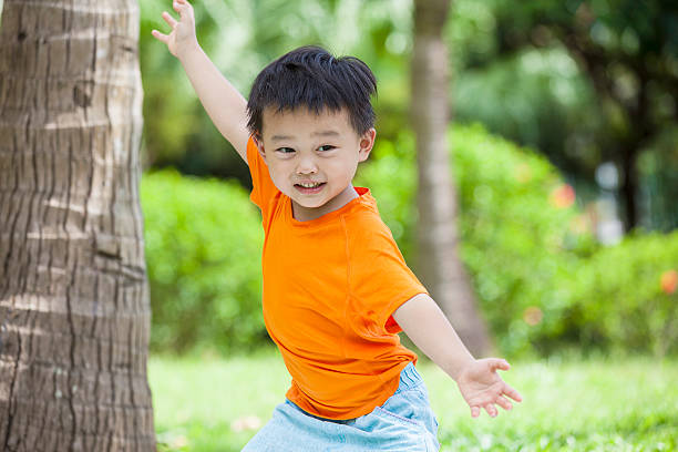 Happy little boy practicing martial arts outdoors stock photo