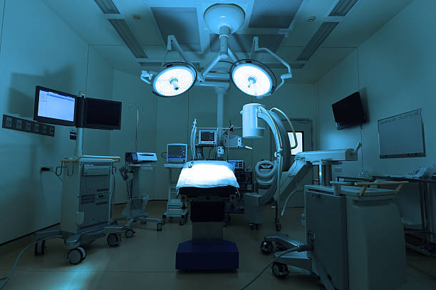 equipment and medical devices in modern operating room equipment and medical devices in modern operating room take with art lighting and blue filter  operating room photos stock pictures, royalty-free photos & images