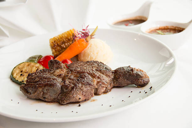 istock cooked rare sirloin steak  on a white plate 596384598