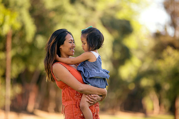 istock Beautiful Asian mother holding her daughter 596385016