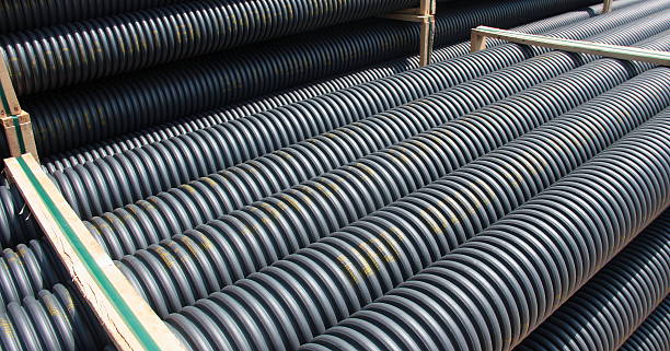 Stack of black corrugated plastic pipes stock photo