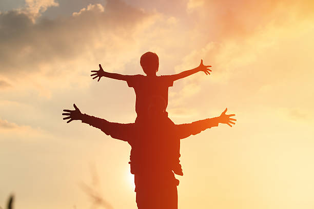 istock father and son play on sunset sky 596389598