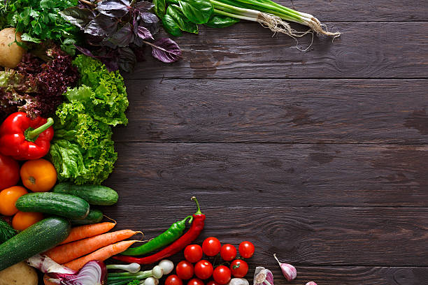 istock Frame of fresh vegetables on wooden background with copy space 596389648