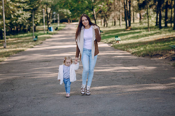 istock young family walking in the park 596390038