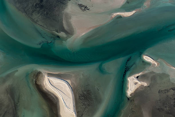 istock Multi Colored Tidal Water Channels Transforming the White Sand Banks 596391042
