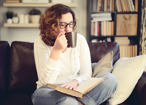 istock Young beautiful woman reading a book 596391374