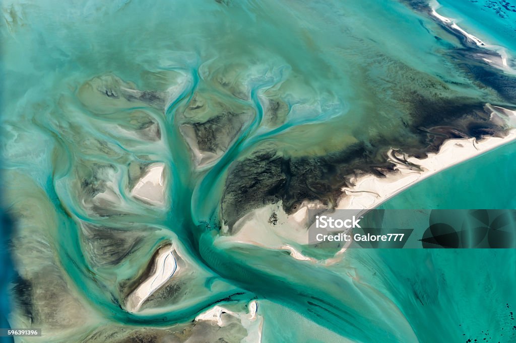 Multi Colored Tidal Water Channels Transforming the White Sand Banks Aerial view of Multi Colored Tidal Water Channels Transforming the White Sand Banks on a Sunny Day at Shark Bay Western Australia Landscape - Scenery Stock Photo