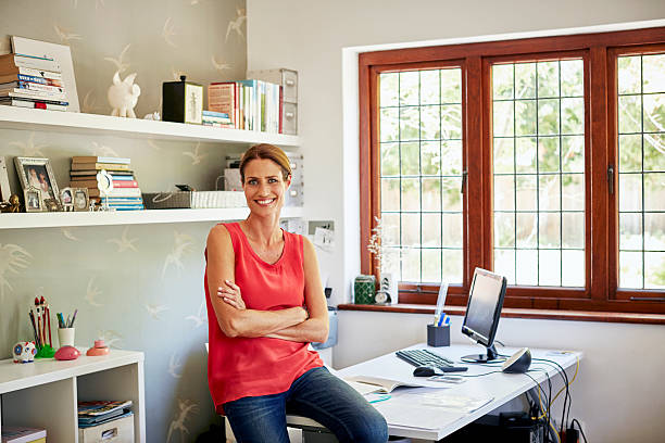 Confident woman sitting on desk