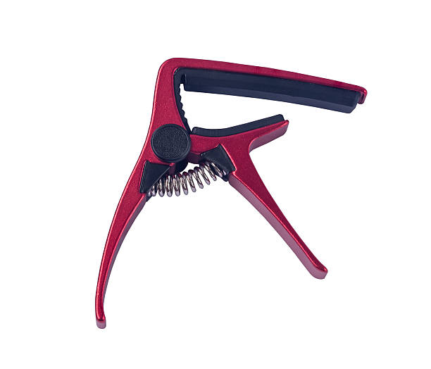 istock Guitar blue capo on white background , close up 596767500