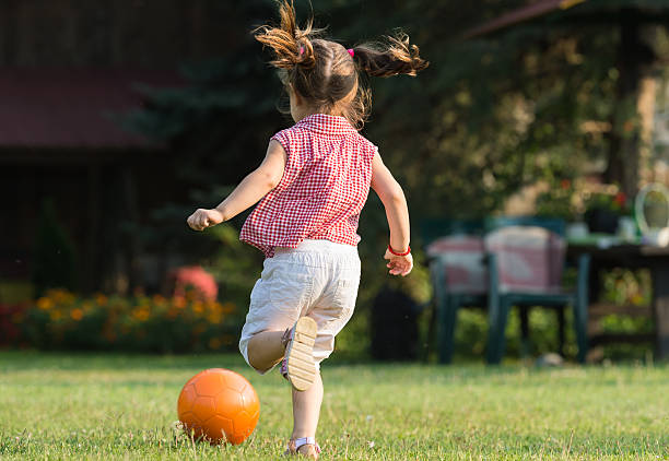 istock Girl kicking ball 596768252