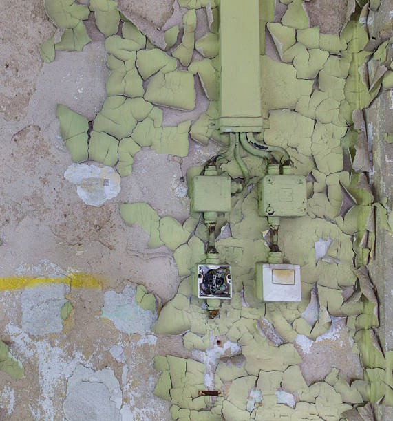istock wall with flaking paint and old electric installation 596770296