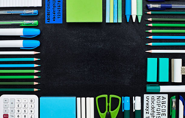 istock School and office supplies are arranged in frame on blackboard 596770652