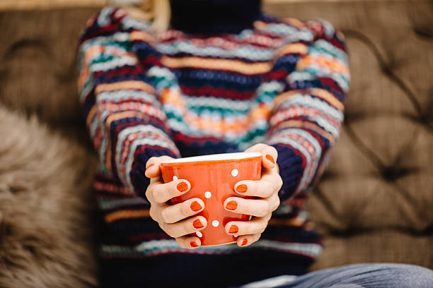 istock Female hands with hot drink, home background 596770732