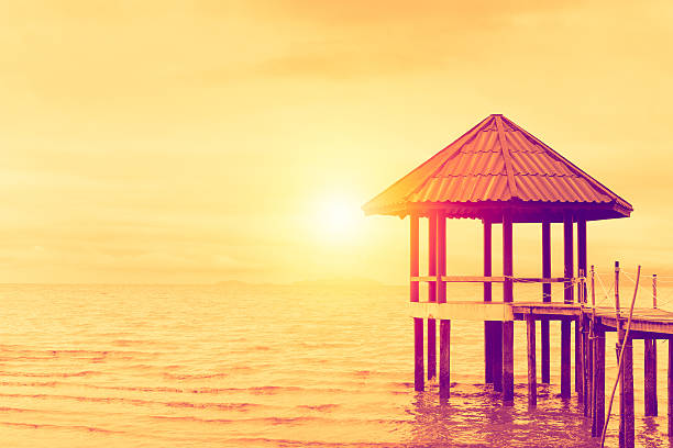 The pavilion in the sea and sunset background. stock photo