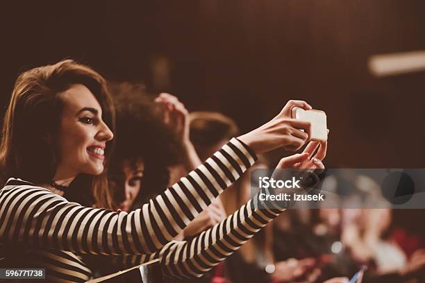 Young People At The Concert Taking Selfie Using Mobile Stock Photo - Download Image Now