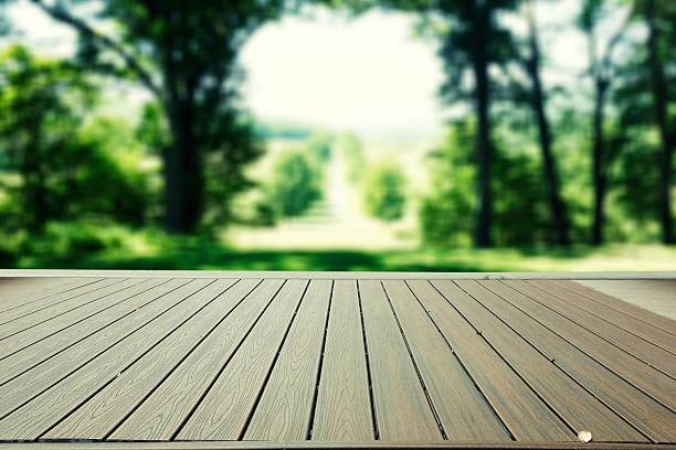istock Wooden floor and defocused forest on background 596772822