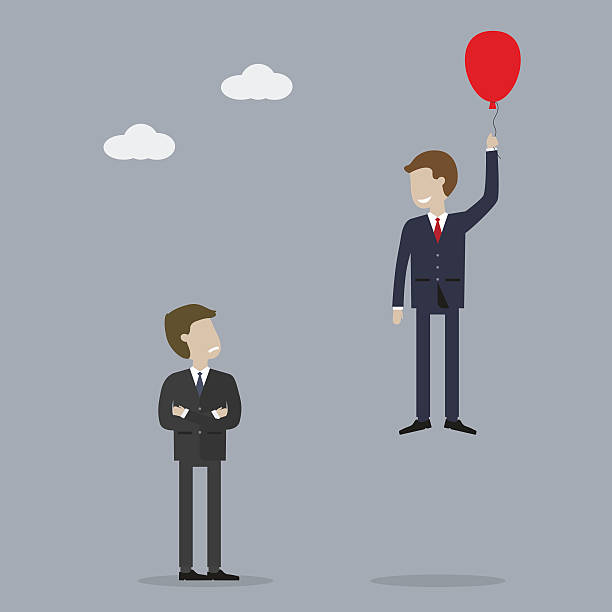 istock Businessman Takes Off in a Balloon 596773182