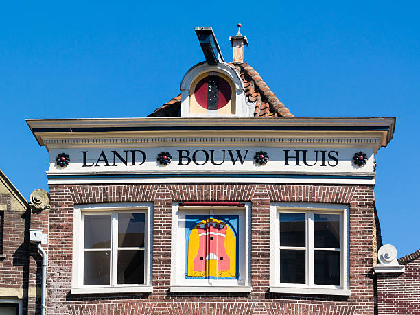Alkmaar, Netherlands - August 17, 2016: Top facade of old house Landbouwhuis on Voordam in Alkmaar, North Holland, Netherlands