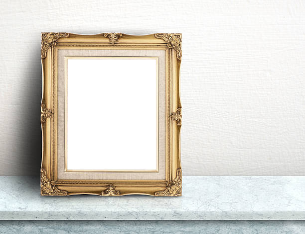 istock Blank Gold victorian picture frame on white marble table 596773922