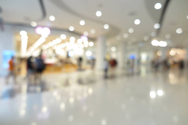 istock Shopping mall interior with people in blur background 596774526
