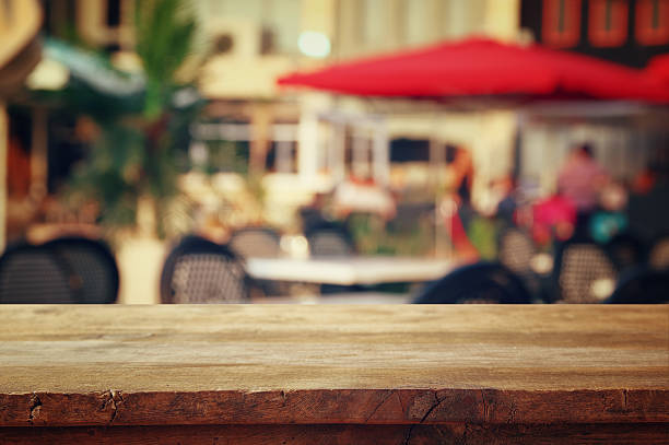 istock table in front of abstract blurred background of restaurant view 596774934