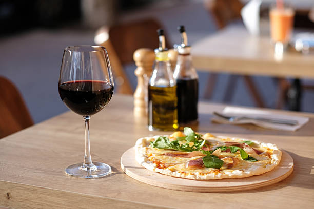 istock Pizza and red wine in restaurant 596776160