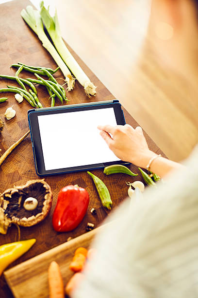 istock Cropped image of woman touching blank screen of tablet computer 596781156