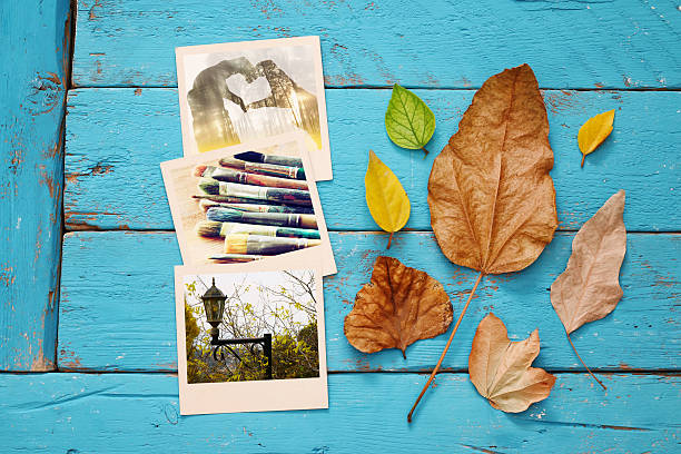 istock Autumn background with dry leaves and old photo frames 596783394
