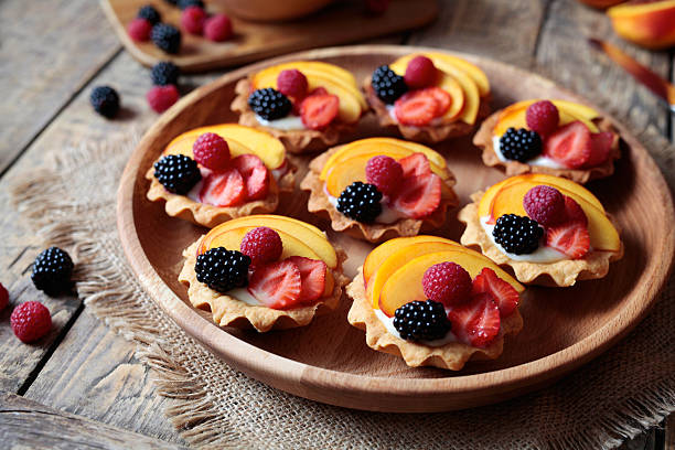 istock Fruit dessert tartlets with vanilla custard and fresh raspberries, blackberry 596784806