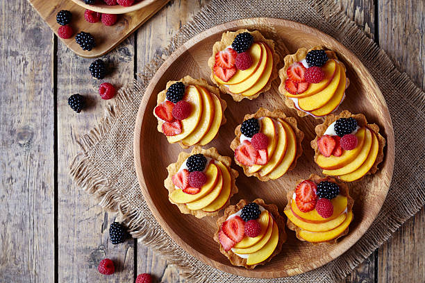 istock Fruit dessert tartlets with vanilla custard and fresh raspberries, blackberry 596785072