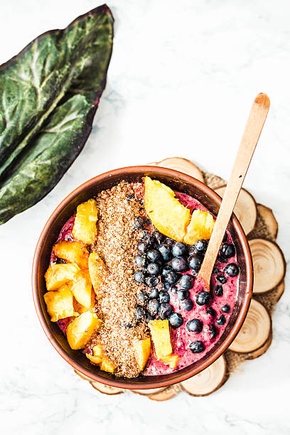 istock smoothie bowl with peach, blueberry, ground flax and peanut butter 596786600