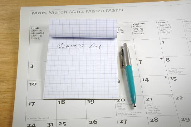 istock Desktop with notebook, pen and calendar. Women's day concept. 596786860