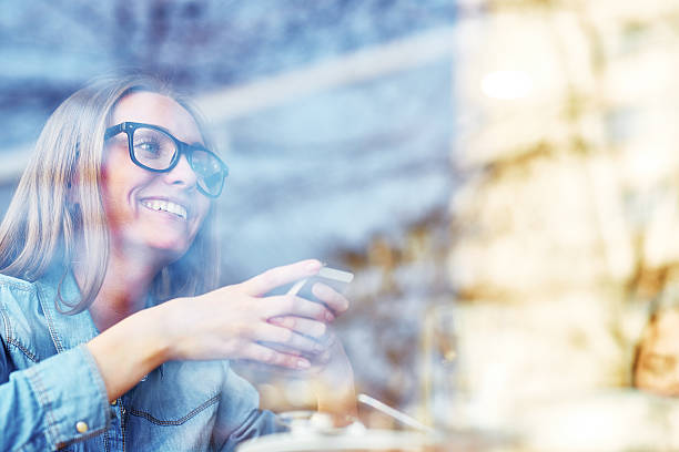 istock Smiling Woman in Glasses in Cafe 596787294