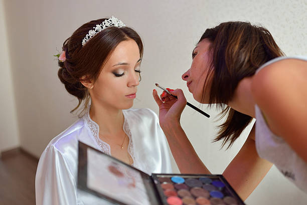 istock Stylist makes makeup bride on the wedding day 596787692